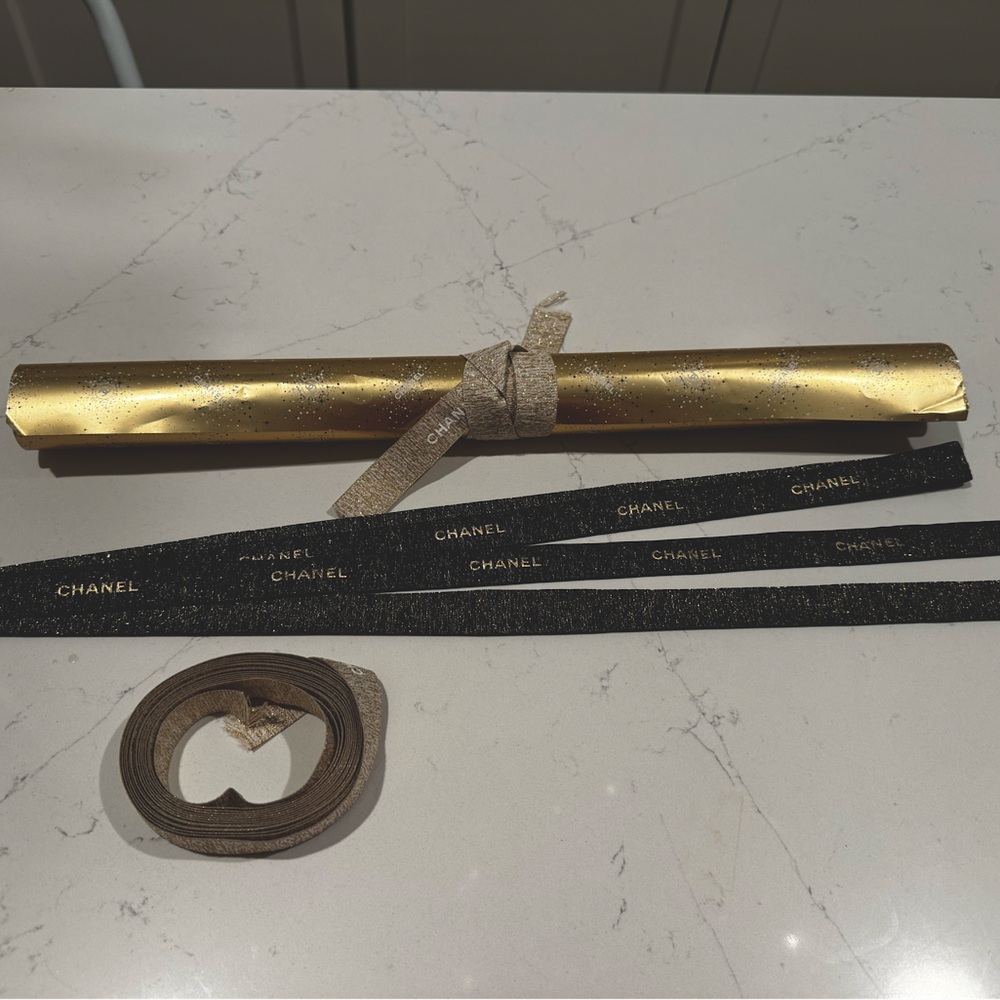 CHANEL wrapping paper with gold and blue sparkly ribbons and three #5 charms!!!